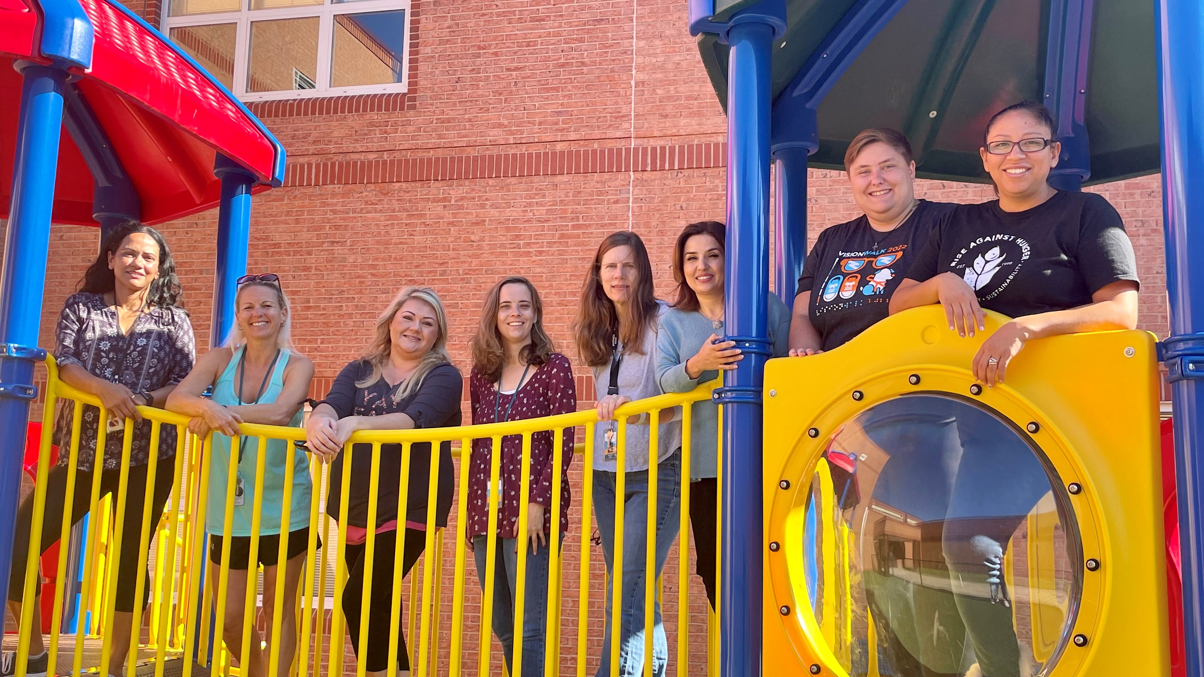 PAC teachers and instructional assistants on playground. 